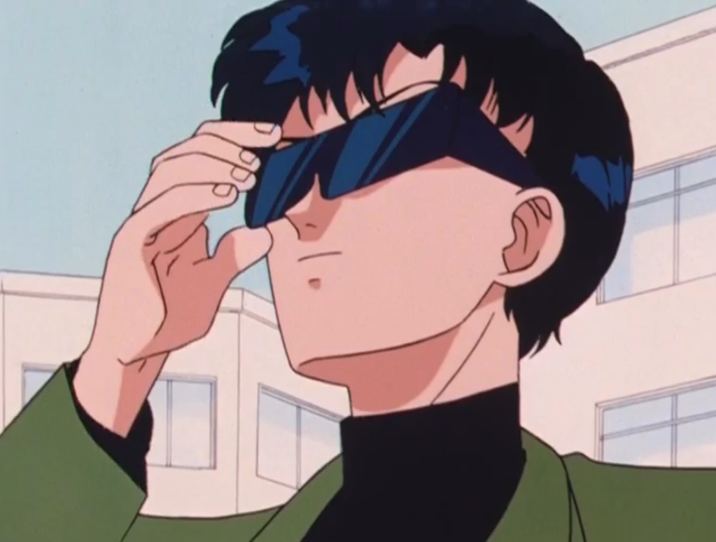 Tuxedo Mask in his everyday clothes, including a huge pair of sunglasses.